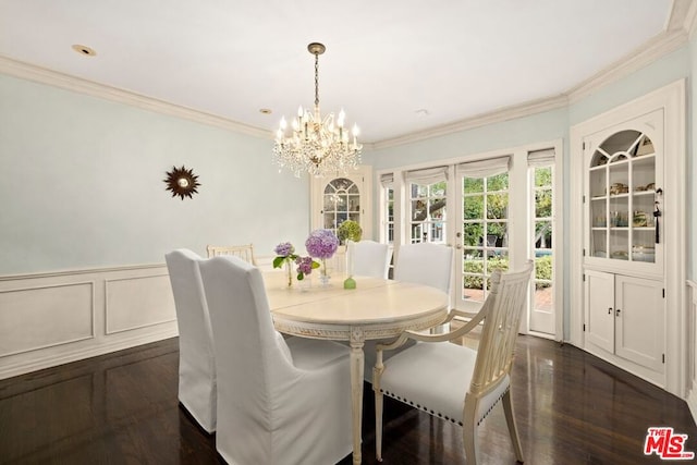 dining area with dark hardwood / wood-style floors, french doors, crown molding, and a chandelier