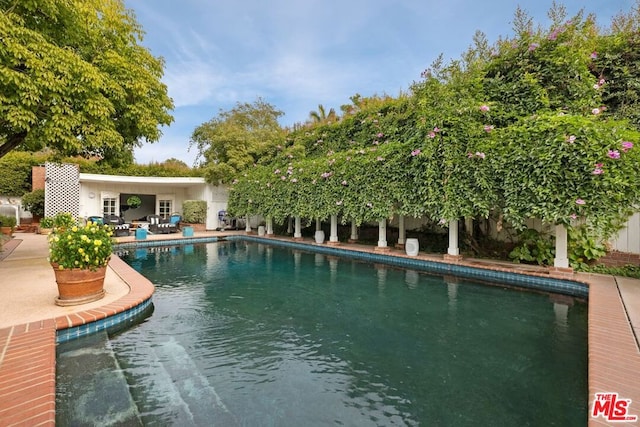 view of swimming pool featuring an outdoor structure