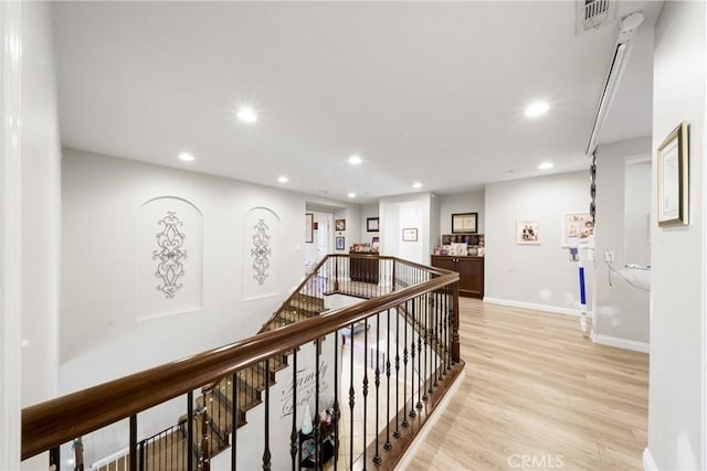 corridor with light hardwood / wood-style flooring