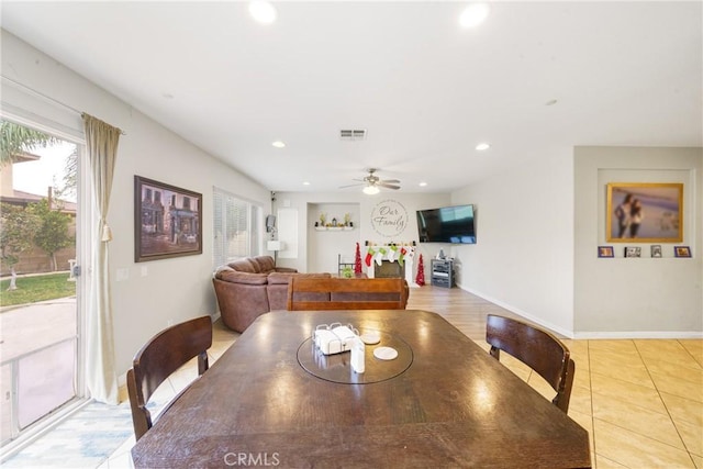 tiled dining room featuring ceiling fan