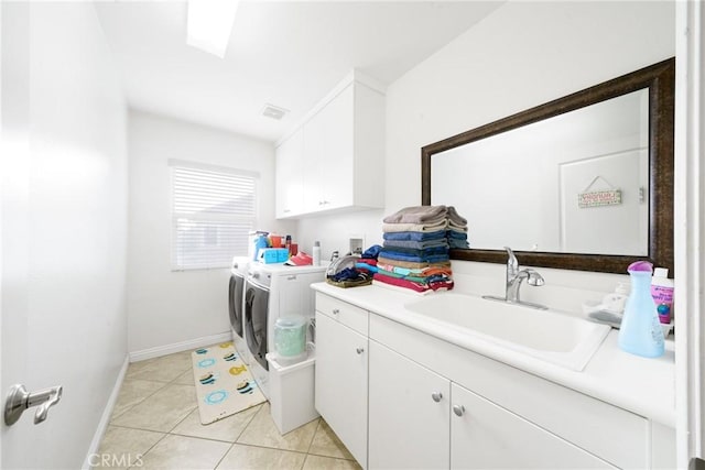 laundry room with cabinets, separate washer and dryer, sink, and light tile patterned floors