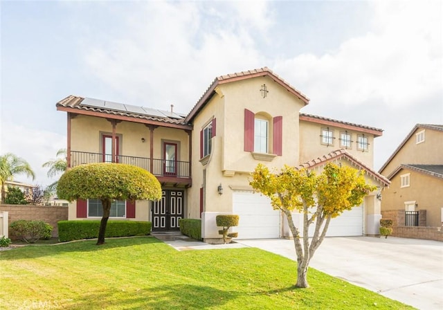 mediterranean / spanish home with solar panels, a garage, a balcony, and a front lawn