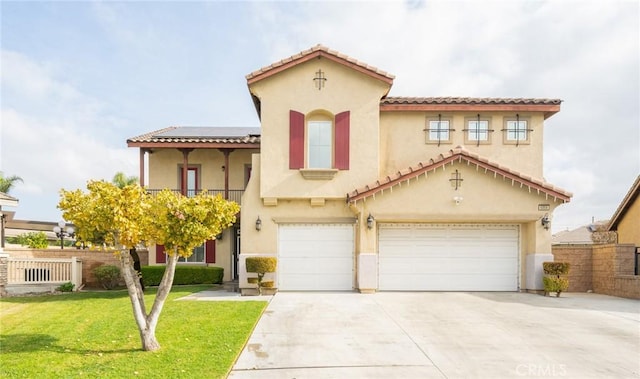 mediterranean / spanish house with a garage and a front lawn