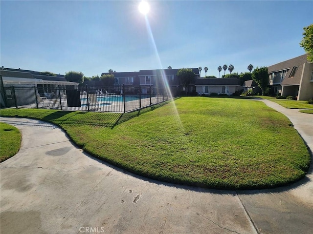 view of community with a yard and a pool