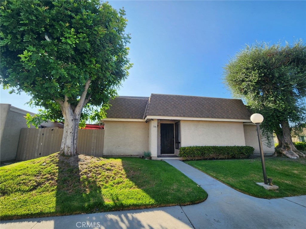 ranch-style home featuring a front lawn