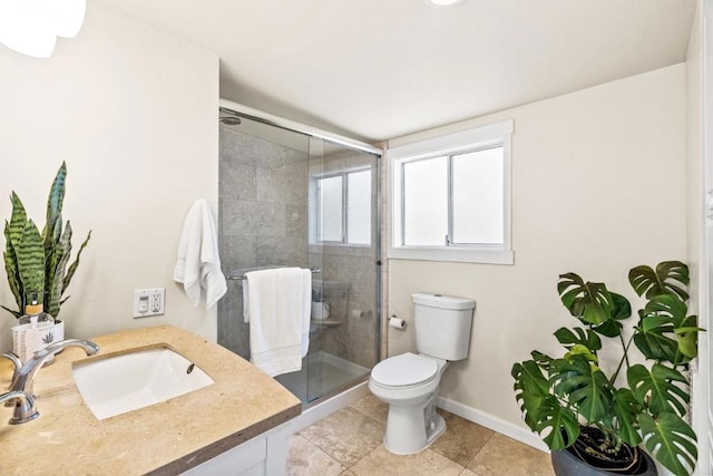 bathroom featuring toilet, tile patterned flooring, walk in shower, and vanity