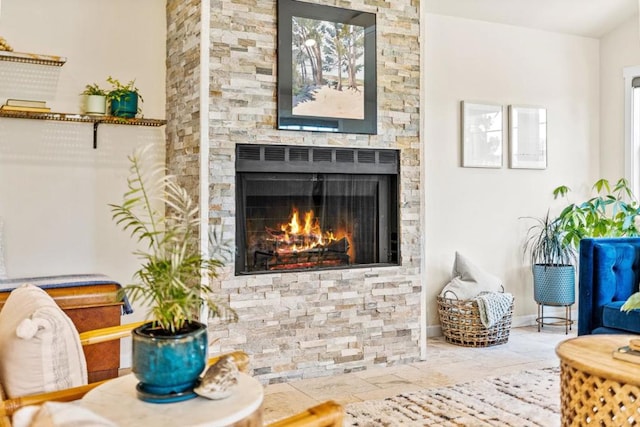 sitting room with a stone fireplace