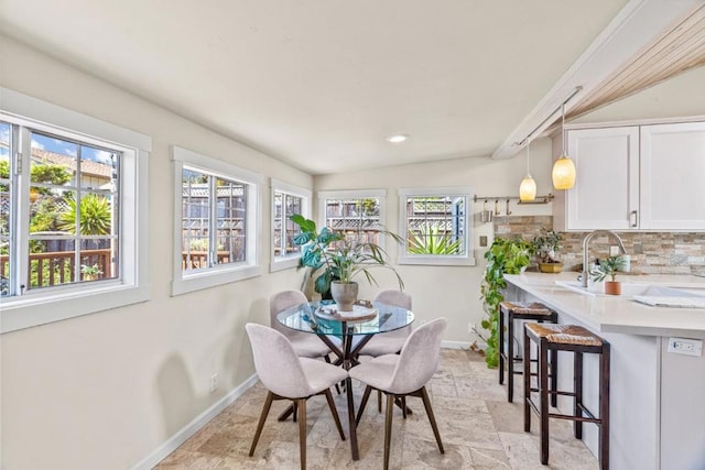 dining room with lofted ceiling and sink