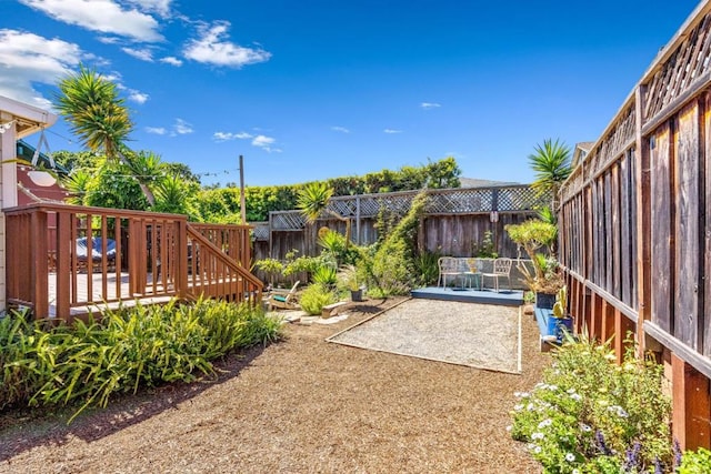 view of yard featuring a patio and a deck