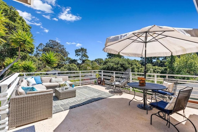 view of patio featuring a balcony and an outdoor living space