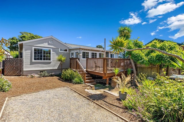 rear view of property featuring a deck