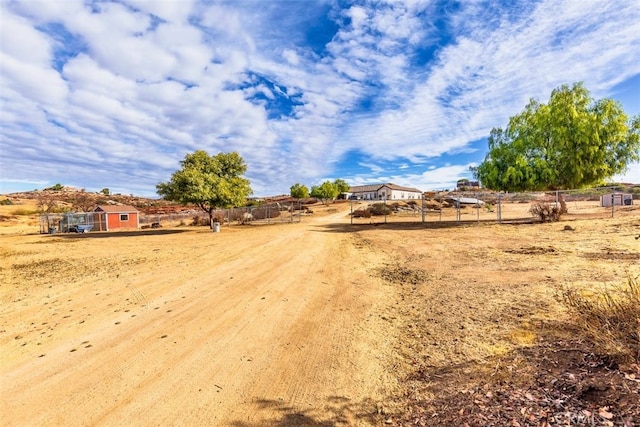 view of yard with a rural view and fence