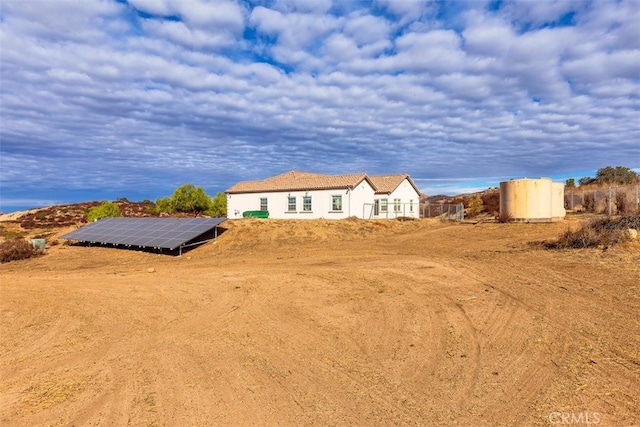 view of front of home featuring solar panels