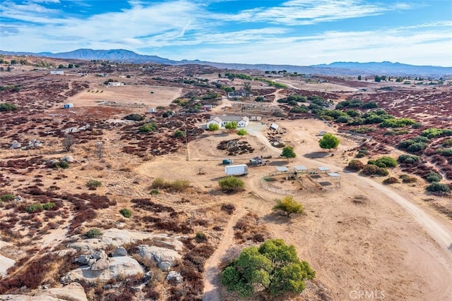 drone / aerial view featuring a desert view and a mountain view