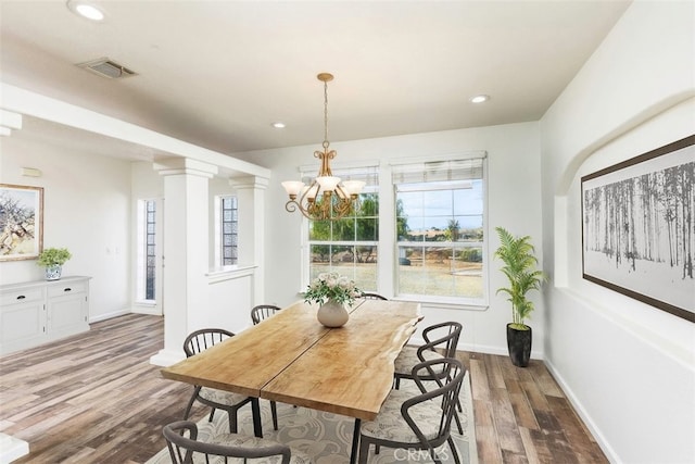 dining space with ornate columns, visible vents, wood finished floors, and recessed lighting