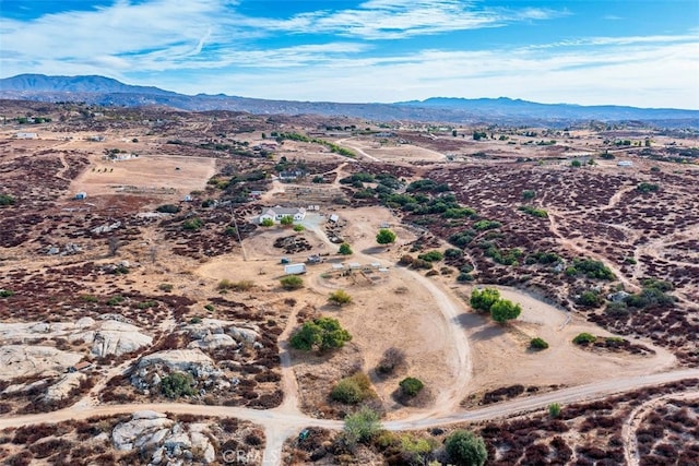 aerial view featuring a mountain view and a desert view