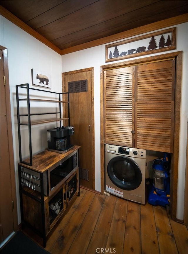 clothes washing area featuring washer / clothes dryer, wooden ceiling, and dark hardwood / wood-style floors