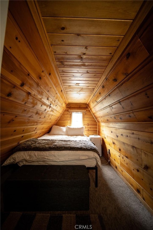 unfurnished bedroom with carpet, lofted ceiling, wooden walls, and wooden ceiling