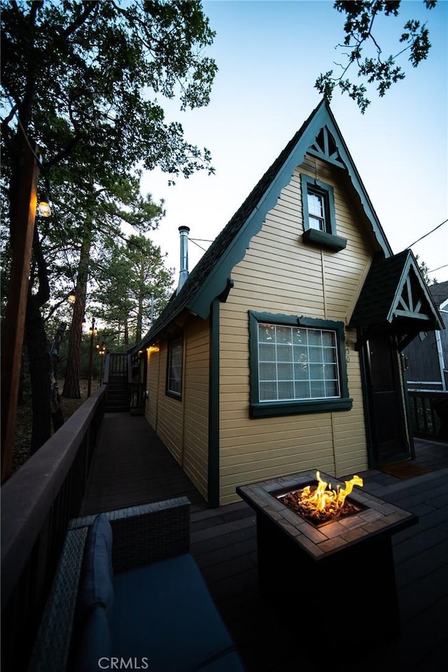 view of side of home featuring a fire pit