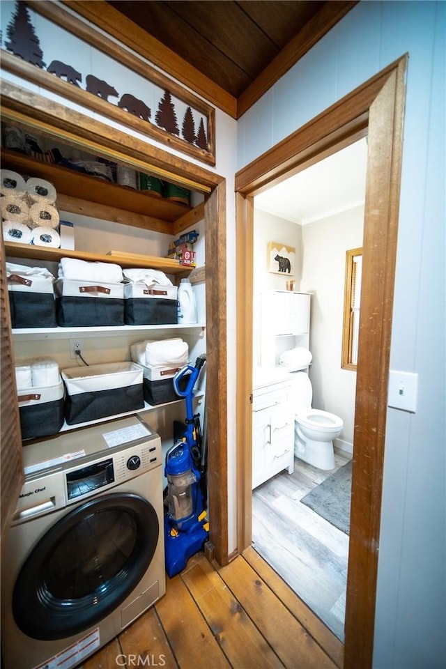 laundry room with washer / clothes dryer, light hardwood / wood-style flooring, and ornamental molding