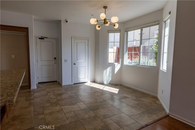 unfurnished dining area with an inviting chandelier