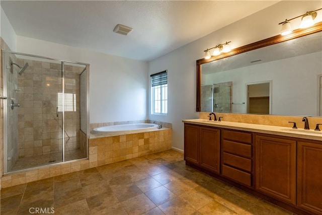 bathroom with vanity and shower with separate bathtub