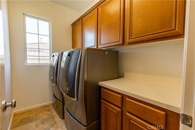 washroom featuring washer and clothes dryer and cabinets