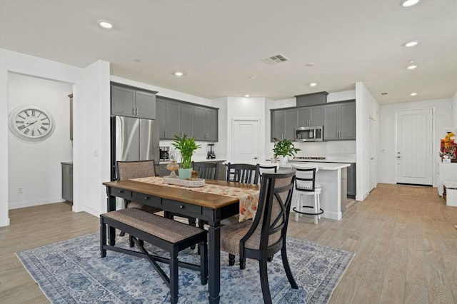 dining space with light wood-type flooring