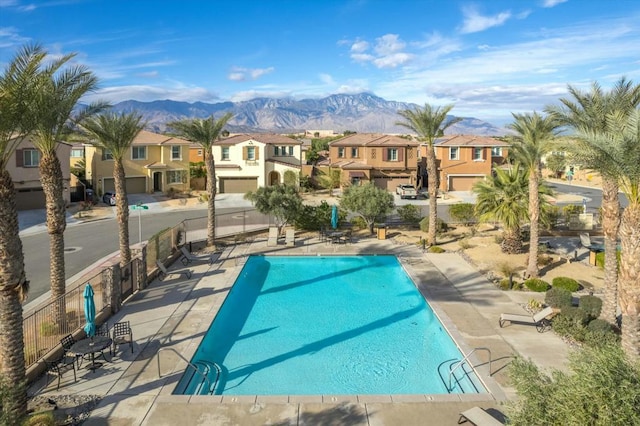 view of swimming pool with a mountain view and a patio