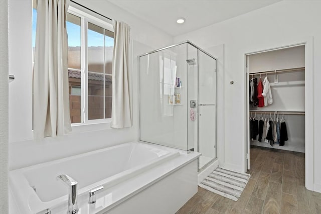 bathroom featuring hardwood / wood-style flooring and independent shower and bath