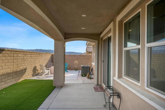 view of patio featuring a mountain view and central AC unit