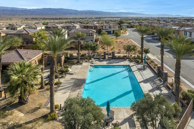 view of pool featuring a mountain view and a patio area