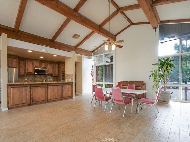 308 S Miraleste Dr Unit 57, San Pedro, CA 90732 - dining area featuring beamed ceiling, ceiling fan, light wood-type flooring, and high vaulted ceiling