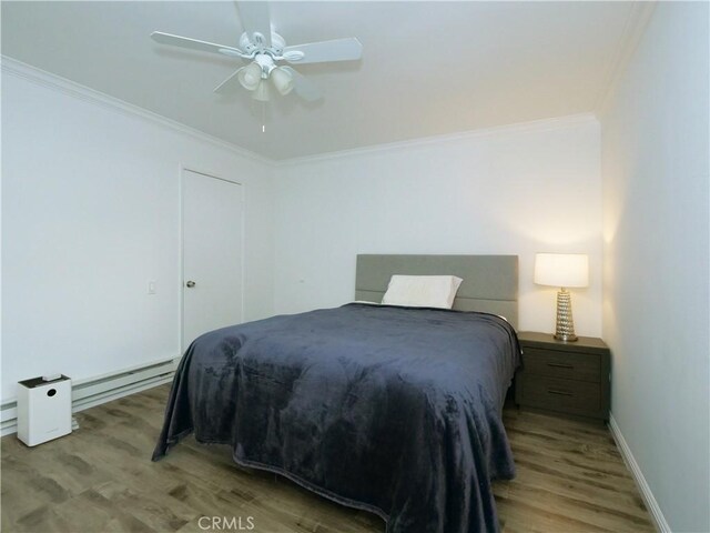 308 S Miraleste Dr Unit 57, San Pedro, CA 90732 - bedroom featuring ceiling fan, crown molding, light hardwood / wood-style floors, and a baseboard heating unit