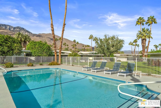 view of swimming pool with a mountain view