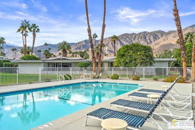 view of swimming pool featuring a patio area and a mountain view