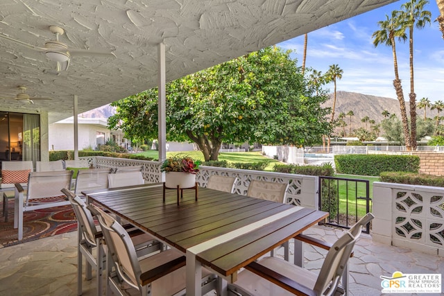 view of patio featuring a mountain view and ceiling fan