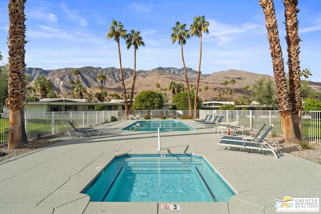 view of swimming pool with a mountain view and a patio