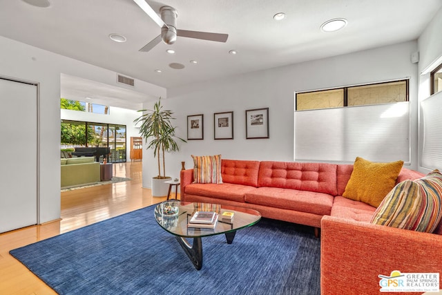 living room with hardwood / wood-style floors and ceiling fan