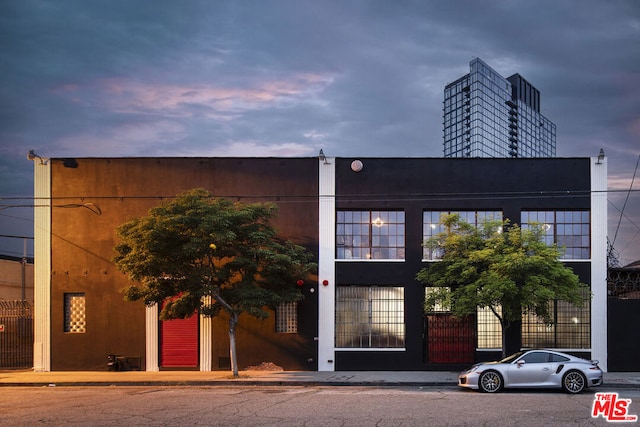 view of outdoor building at dusk