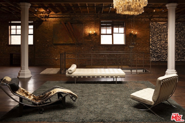 interior space featuring wood-type flooring and brick wall