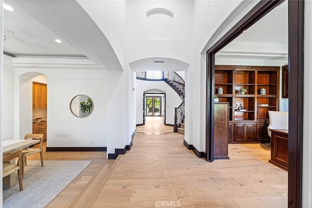 hallway with built in features and light hardwood / wood-style flooring