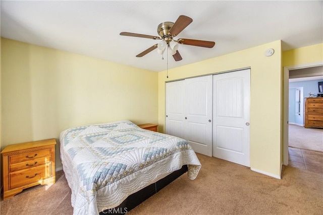 bedroom featuring light carpet, a closet, and ceiling fan