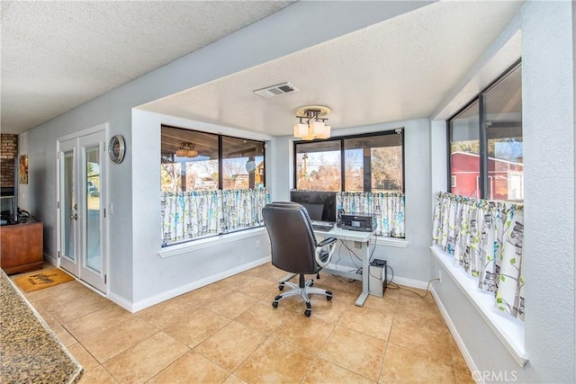 tiled home office featuring a textured ceiling