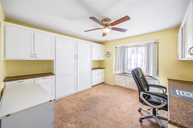 unfurnished office featuring light colored carpet and ceiling fan