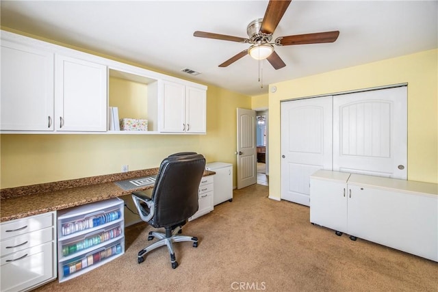 office space featuring light colored carpet and ceiling fan