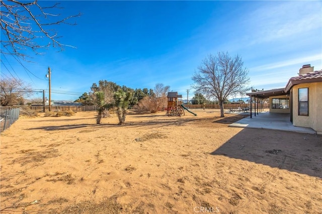 view of yard featuring a patio and a playground