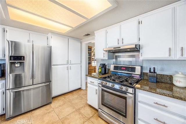 kitchen with white cabinetry, appliances with stainless steel finishes, and dark stone countertops