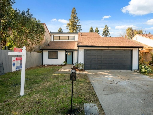 view of front of home featuring a garage and a front yard