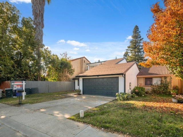 view of front facade with a front yard and a garage